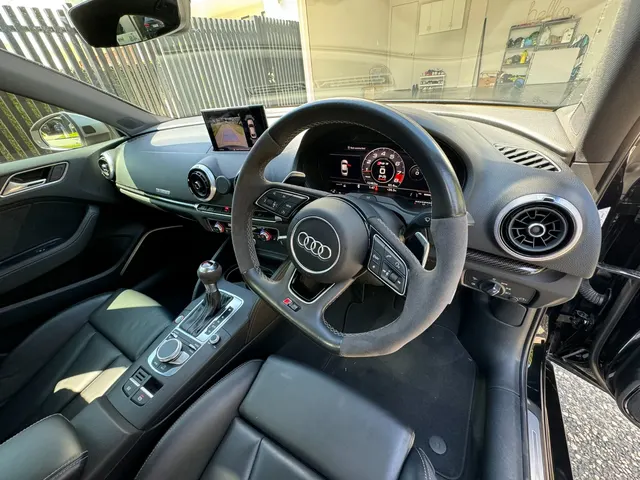 Audi RS3 cabin with leather front seats, steering wheel and centre console