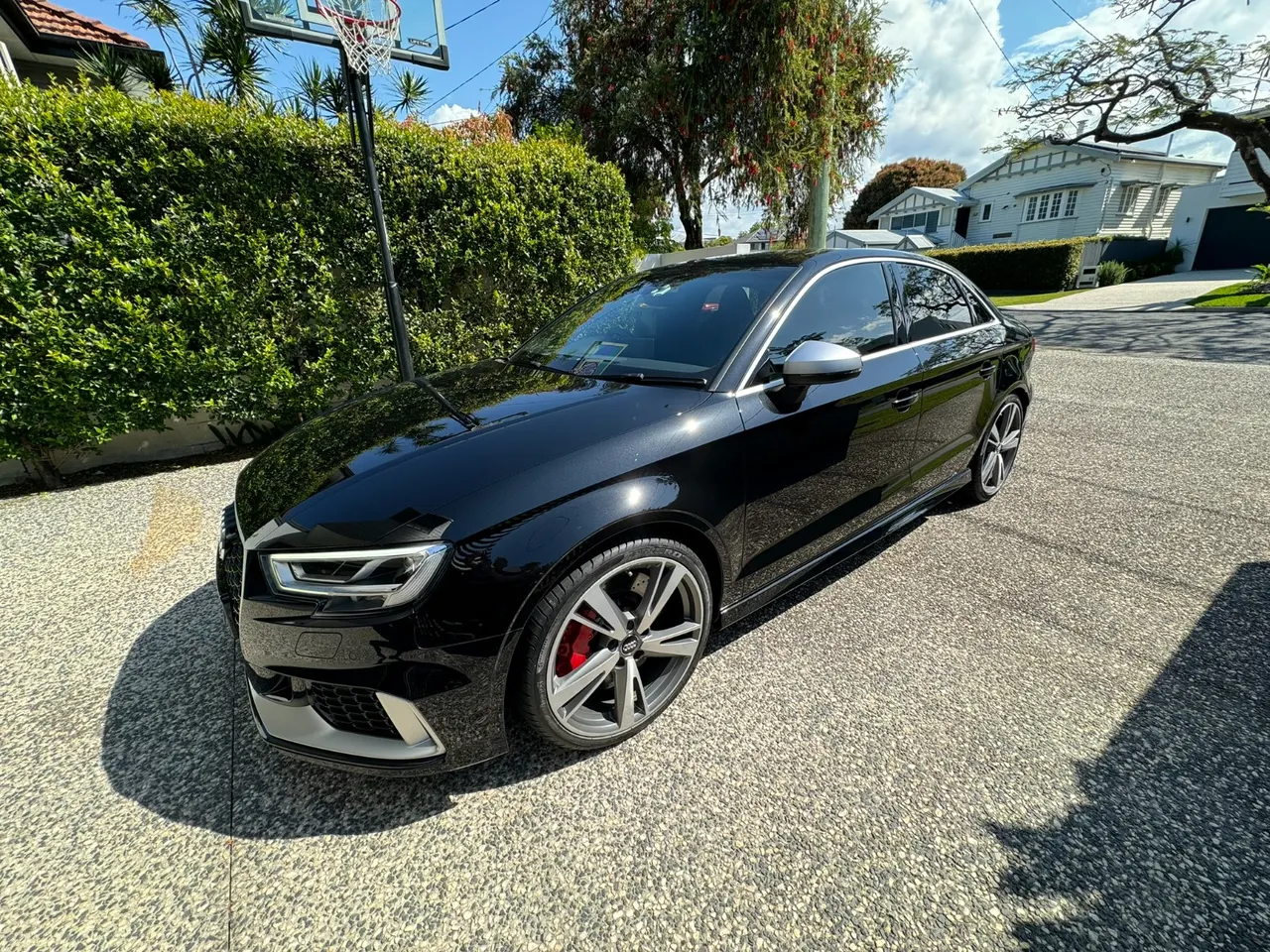 The black Audi RS3 sedan in the afternoon sun